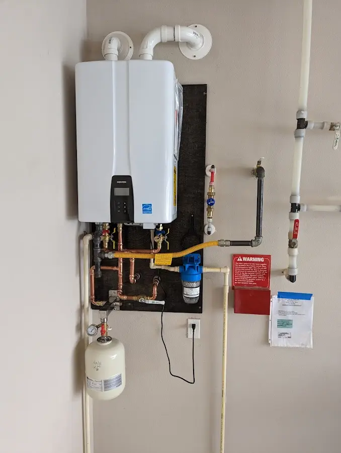 Professional plumber installing copper piping in a Llano home